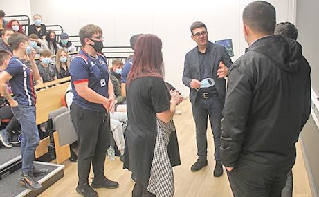 Andy talking with students and staff